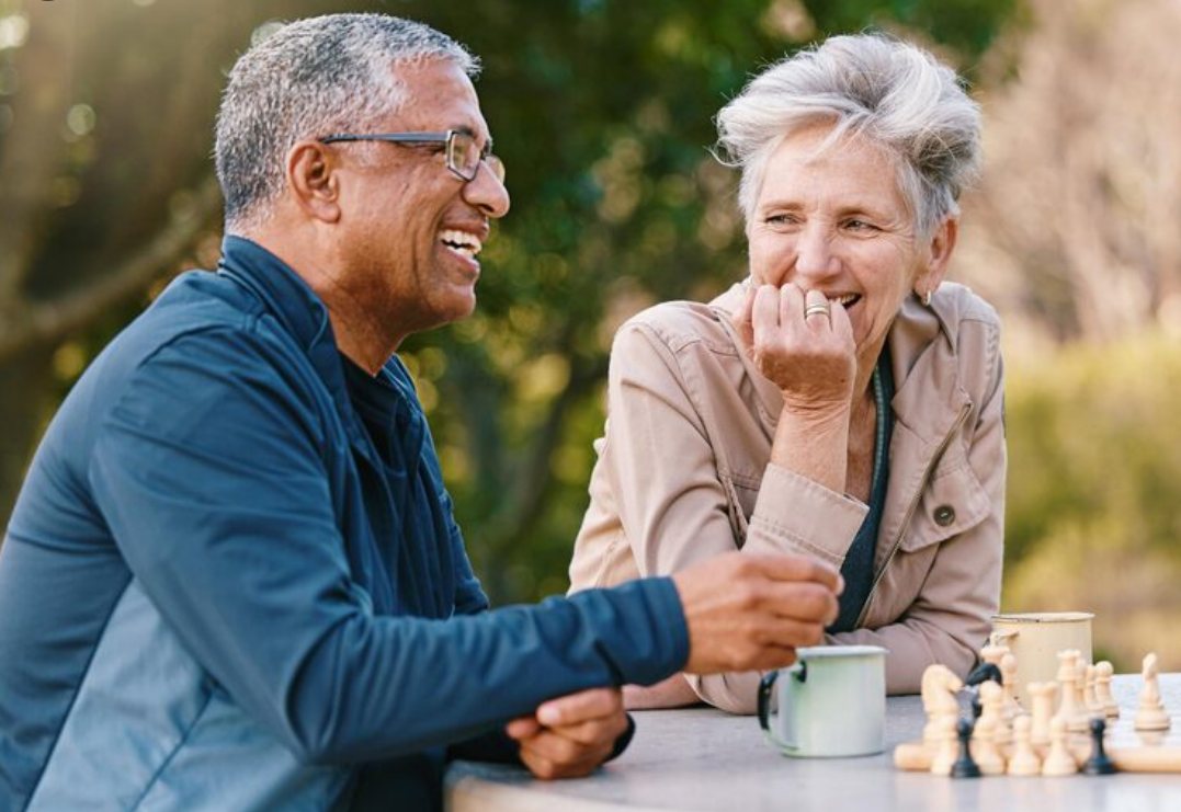 Two senior singles talking warmly over coffee